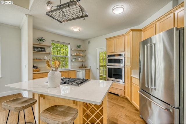 4630 Summerlinn Way W, Linn, OR 97068 - kitchen featuring appliances with stainless steel finishes, open shelves, light brown cabinetry, light wood-style floors, and light countertops