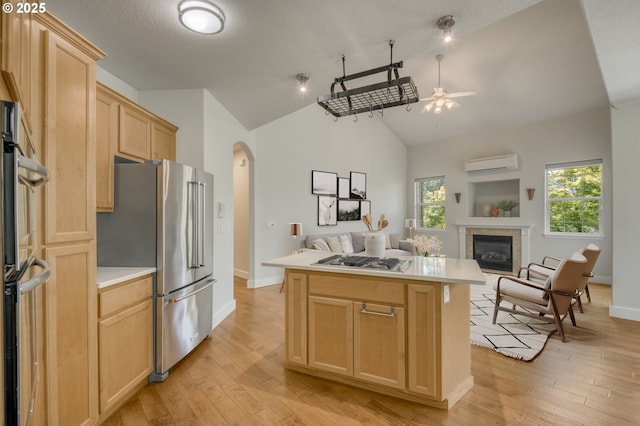 4630 Summerlinn Way W, Linn, OR 97068 - kitchen featuring open floor plan, appliances with stainless steel finishes, light brown cabinets, an AC wall unit, and high vaulted ceiling