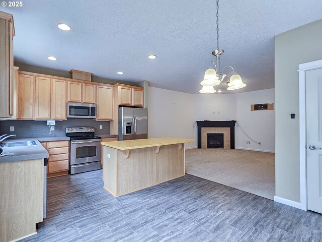 15621 SE Eckert Ln, Damascus, OR 97089 - kitchen featuring appliances with stainless steel finishes, light brown cabinetry, a sink, a center island, and recessed lighting