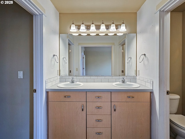 15621 SE Eckert Ln, Damascus, OR 97089 - full bathroom with toilet, double vanity, and tasteful backsplash