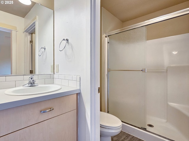 15621 SE Eckert Ln, Damascus, OR 97089 - full bathroom with a stall shower, vanity, toilet, and wood finished floors