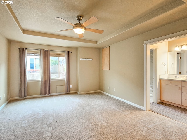 15621 SE Eckert Ln, Damascus, OR 97089 - spare room featuring a raised ceiling, light colored carpet, ceiling fan, a textured ceiling, and a sink