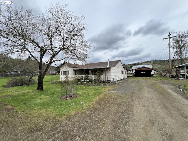 524 Buckhorn Rd, Roseburg, OR 97470 - view of front of home with a porch, driveway, a carport, and a front lawn