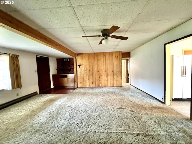 524 Buckhorn Rd, Roseburg, OR 97470 - unfurnished living room with wooden walls, a paneled ceiling, carpet floors, and a ceiling fan
