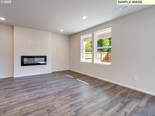 kitchen featuring a kitchen breakfast bar, a kitchen island, stainless steel appliances, and visible vents