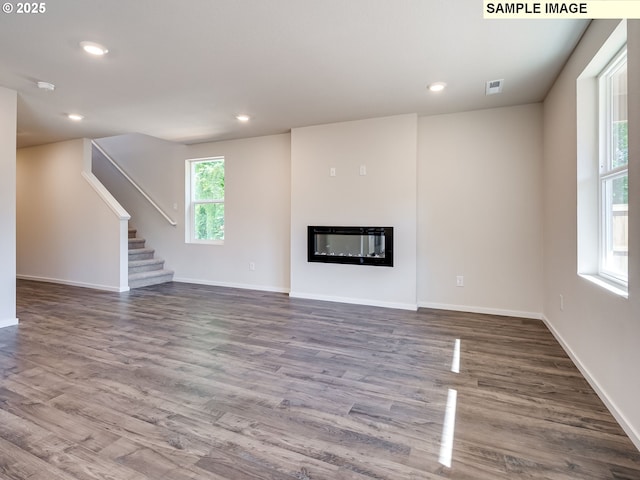kitchen featuring light countertops, a sink, white cabinetry, dark wood-style floors, and stainless steel appliances
