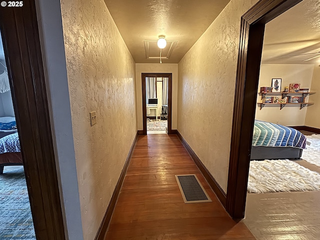 hallway featuring dark hardwood / wood-style flooring