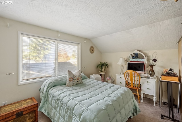 bedroom featuring lofted ceiling, carpet floors, and a textured ceiling