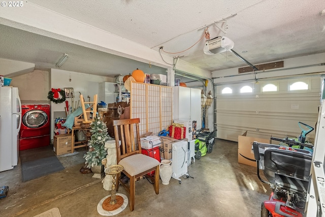 garage featuring freestanding refrigerator, a garage door opener, and washer / clothes dryer