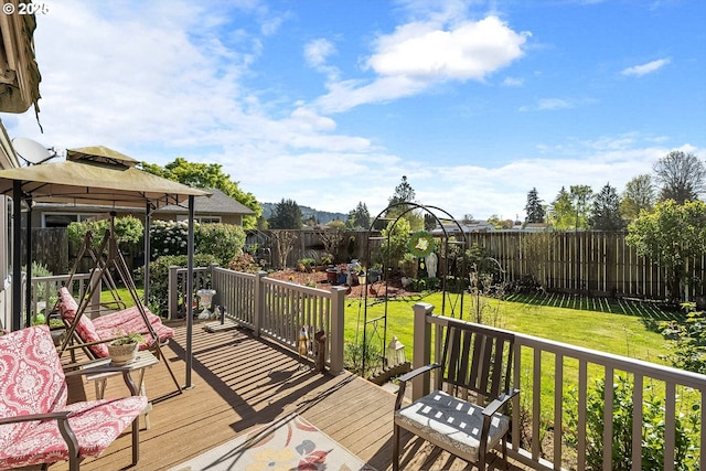 wooden terrace with a gazebo, a lawn, and a fenced backyard