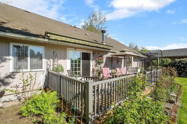 back of property with roof with shingles