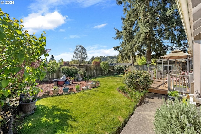 view of yard with a fenced backyard, a gazebo, and a deck