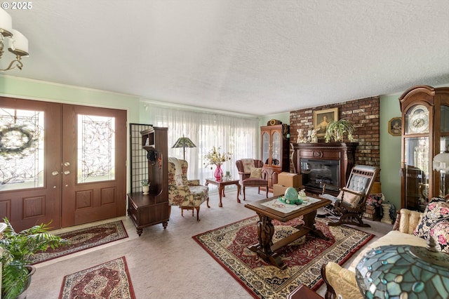 carpeted living area with a fireplace, a textured ceiling, and french doors
