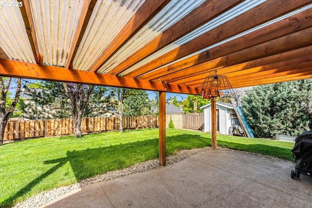 view of patio featuring a fenced backyard, a shed, and an outbuilding