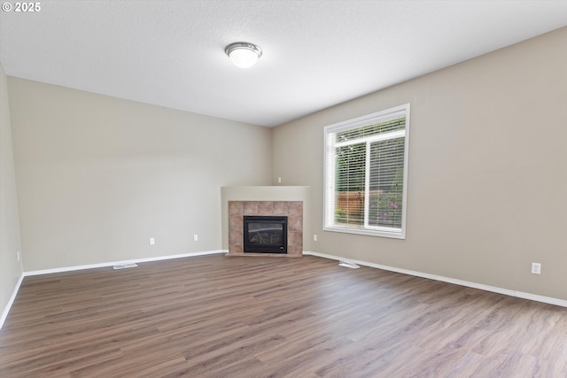 18407 NE 20th St, Vancouver, WA 98684 - unfurnished living room with wood finished floors, baseboards, and a tile fireplace