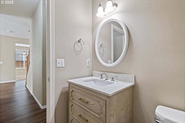 18407 NE 20th St, Vancouver, WA 98684 - half bathroom featuring toilet, vanity, wood finished floors, and baseboards