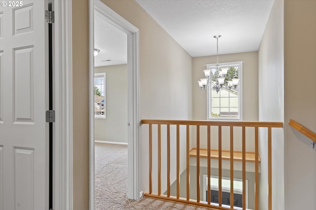 18407 NE 20th St, Vancouver, WA 98684 - hall featuring healthy amount of natural light, carpet floors, a chandelier, a textured ceiling, and baseboards