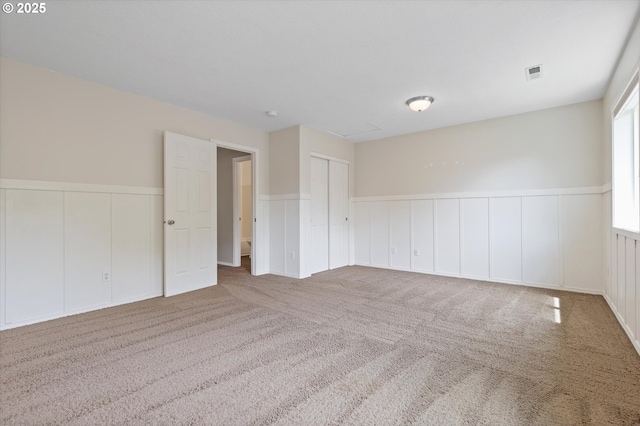 18407 NE 20th St, Vancouver, WA 98684 - spare room featuring wainscoting, a decorative wall, and carpet flooring