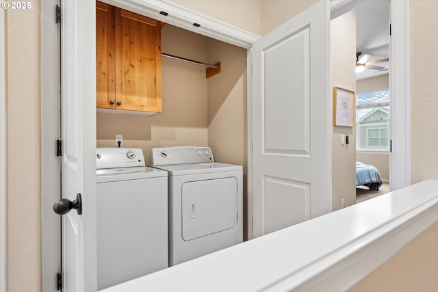 laundry room featuring cabinet space and washer and clothes dryer