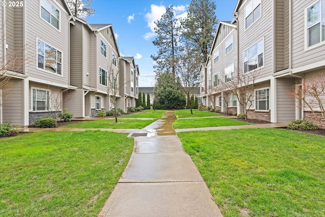 view of community with a yard and a residential view