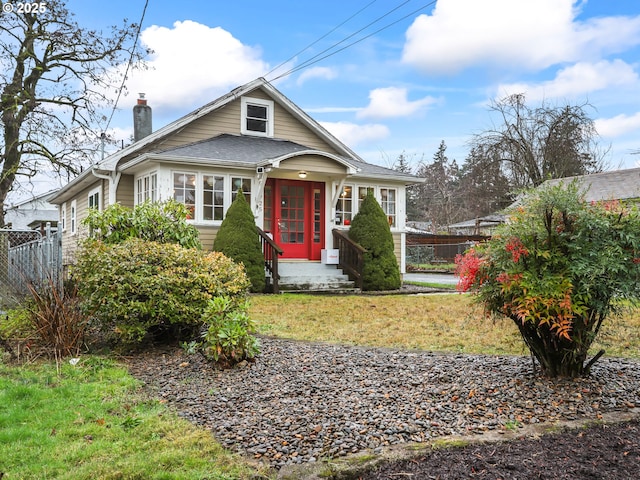 bungalow-style house with a front yard