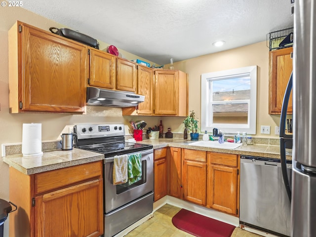 kitchen featuring sink, a textured ceiling, and appliances with stainless steel finishes