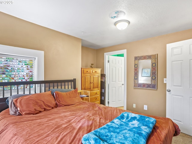 carpeted bedroom featuring a textured ceiling