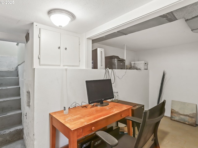 home office featuring a textured ceiling