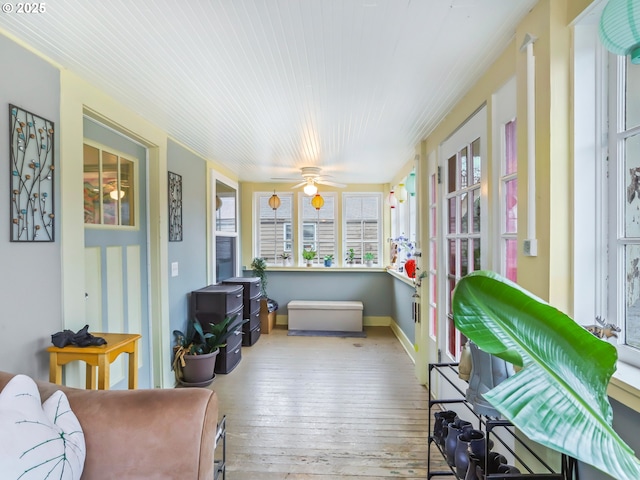 sunroom featuring ceiling fan