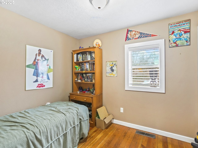 bedroom with hardwood / wood-style floors