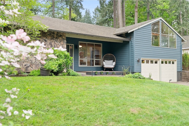 tri-level home with an attached garage, a front lawn, driveway, and stone siding