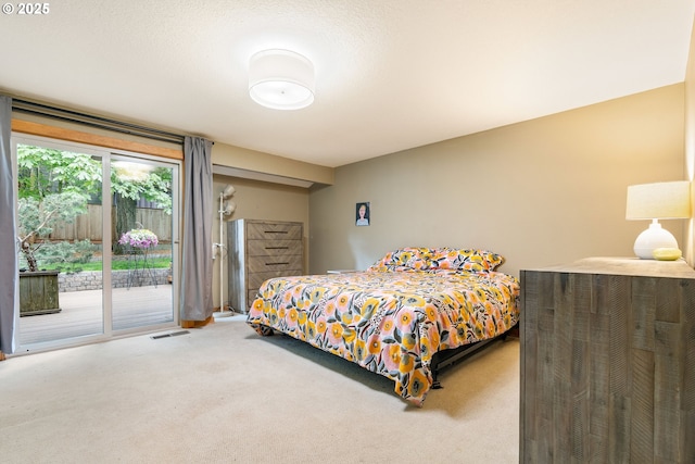 bedroom featuring visible vents, carpet, and access to exterior