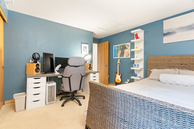 bedroom with attic access and carpet