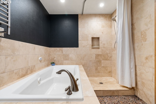 bathroom with recessed lighting, a shower stall, radiator heating unit, and a garden tub