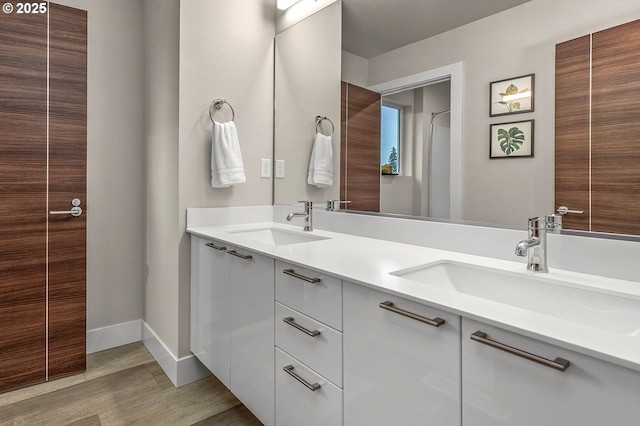 15192 SW Huntwood St, Tigard, OR 97224 - bathroom featuring double vanity and wood finished floors