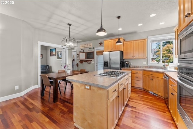 1609 Wood Duck St, Silverton, OR 97381 - kitchen with appliances with stainless steel finishes, light wood finished floors, light brown cabinets, pendant lighting, and recessed lighting
