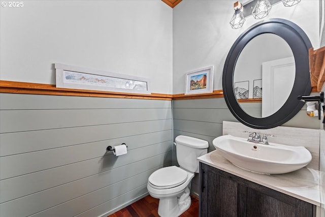 1609 Wood Duck St, Silverton, OR 97381 - half bath featuring vanity, wood finished floors, and a wainscoted wall