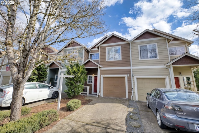 multi unit property featuring a garage and driveway