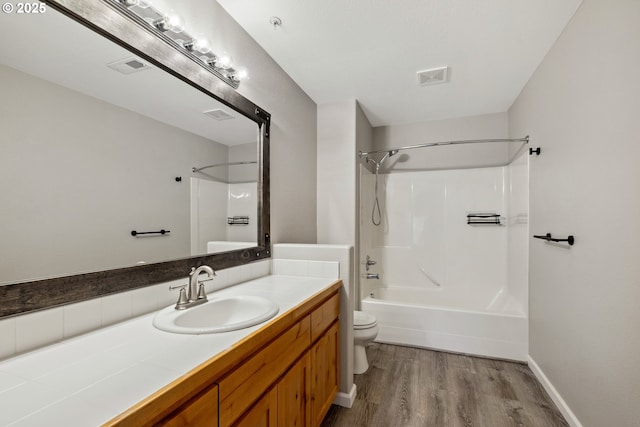 bathroom with visible vents, toilet, wood finished floors, and vanity