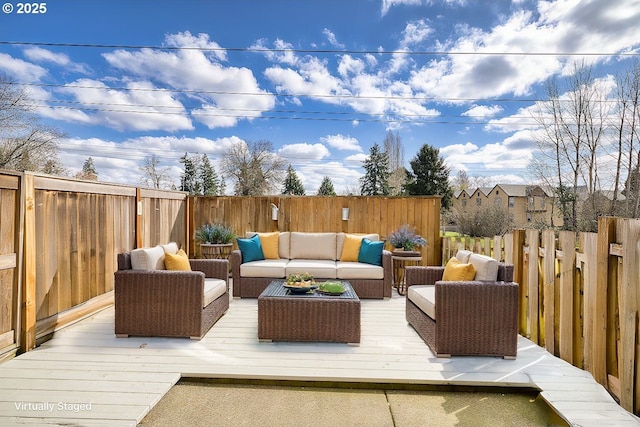 deck featuring an outdoor hangout area and a fenced backyard