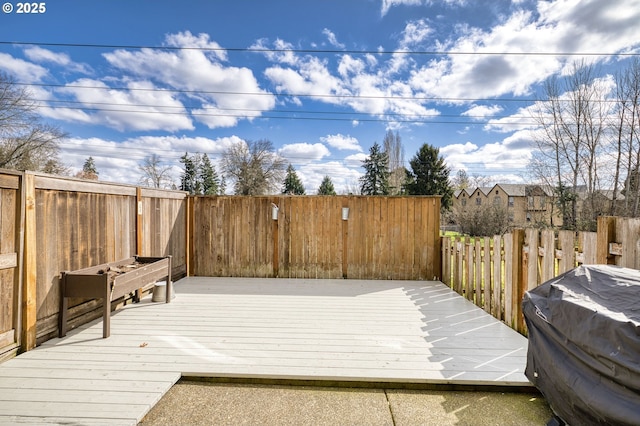 wooden deck featuring a fenced backyard