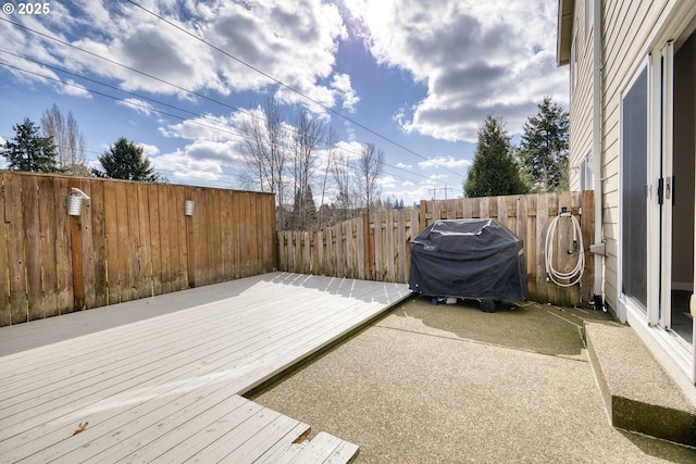 wooden terrace featuring a patio, area for grilling, and a fenced backyard