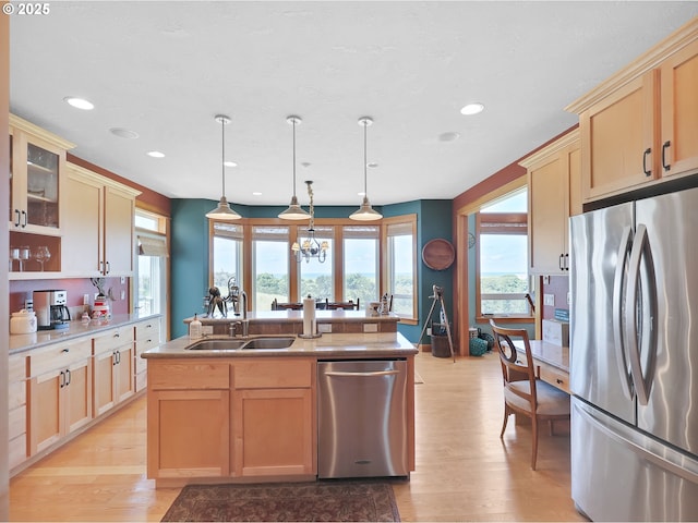 88724 Schroeder Rd, Gearhart, OR 97138 - kitchen featuring appliances with stainless steel finishes, a sink, light brown cabinetry, light wood-style floors, and recessed lighting