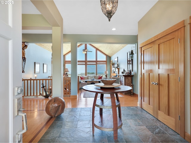 88724 Schroeder Rd, Gearhart, OR 97138 - entryway with stone tile floors, a ceiling fan, vaulted ceiling, and baseboards