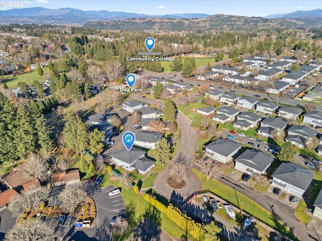 drone / aerial view featuring a residential view and a mountain view