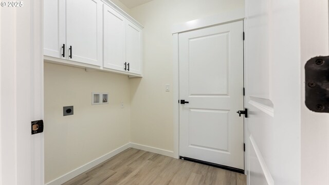 clothes washing area with cabinets, washer hookup, hookup for an electric dryer, and light hardwood / wood-style floors