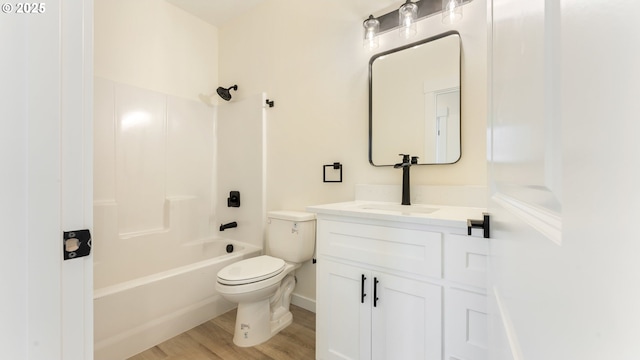 full bathroom featuring toilet, hardwood / wood-style floors, vanity, and shower / bathing tub combination