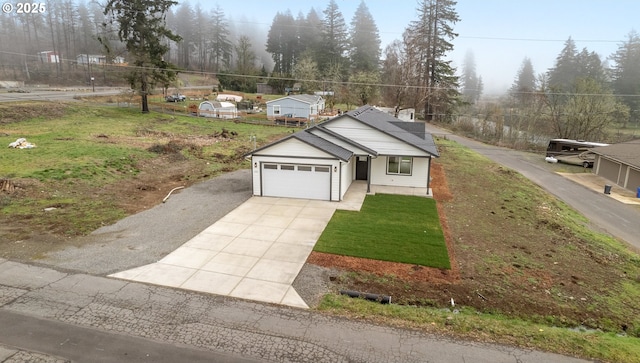 view of front of property featuring a garage and a front yard