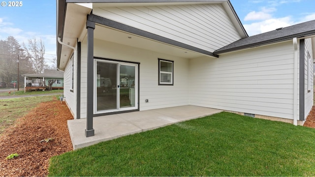 back of property featuring a patio area and a lawn