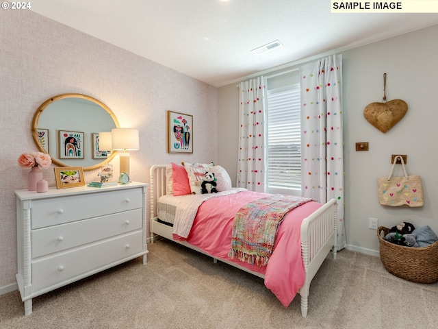 bedroom featuring light carpet